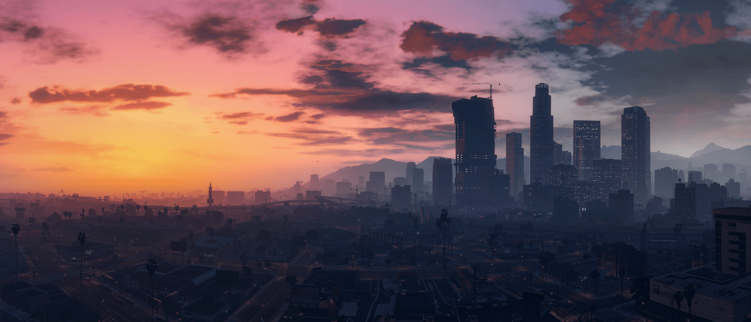 Vue large de Los Santos depuis les hauteurs, en fin de journée.